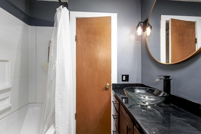 bathroom featuring shower / bath combo and vanity