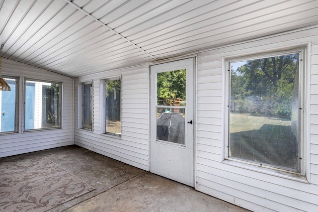 unfurnished sunroom featuring lofted ceiling