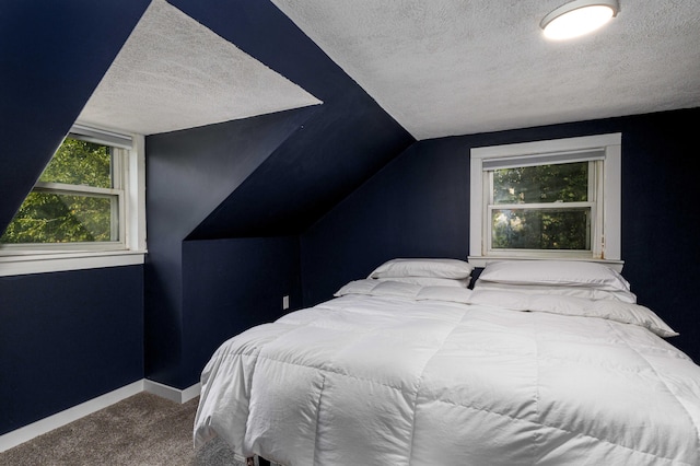 carpeted bedroom with lofted ceiling and a textured ceiling