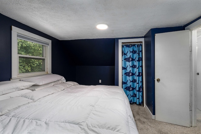 carpeted bedroom featuring a textured ceiling