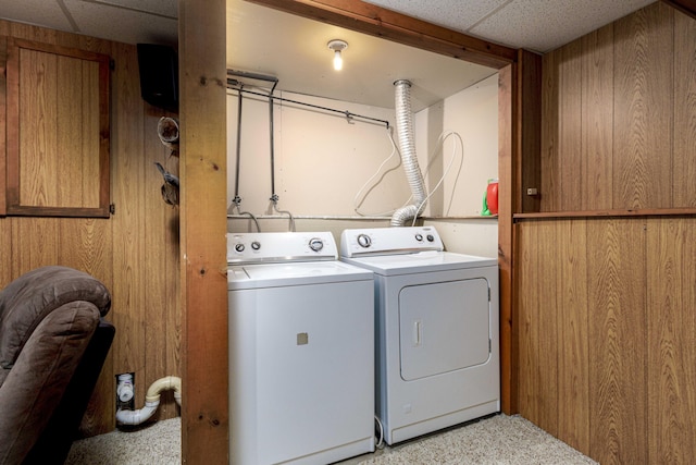 washroom with wooden walls and washer and clothes dryer