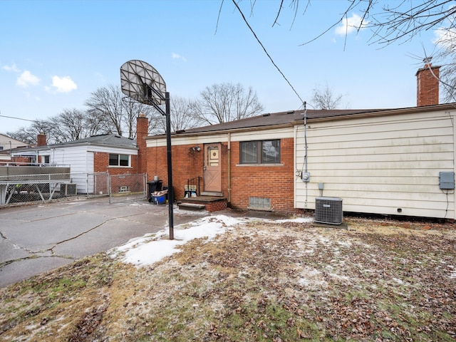 rear view of property with cooling unit