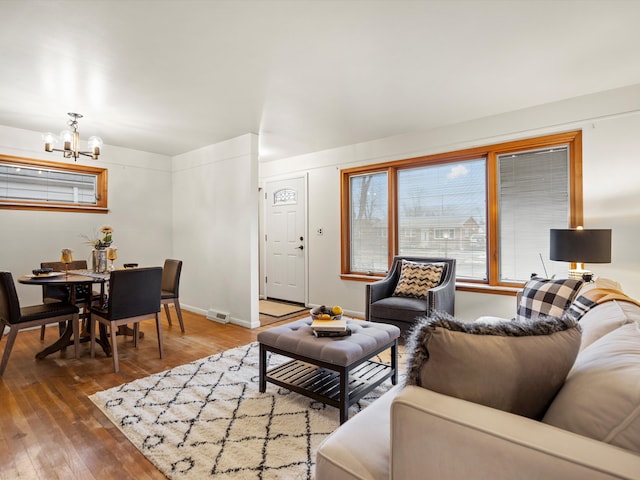 living room featuring an inviting chandelier and hardwood / wood-style floors