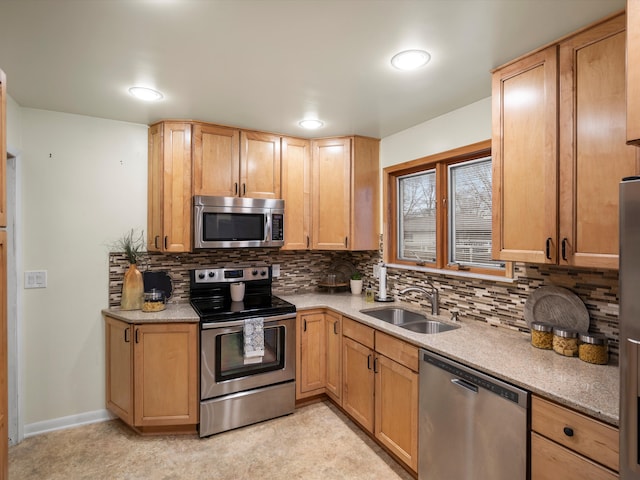 kitchen featuring appliances with stainless steel finishes, sink, and backsplash