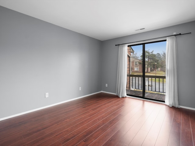 spare room with hardwood / wood-style floors