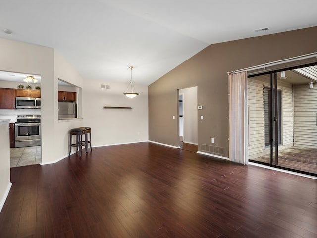 unfurnished living room with lofted ceiling and wood-type flooring