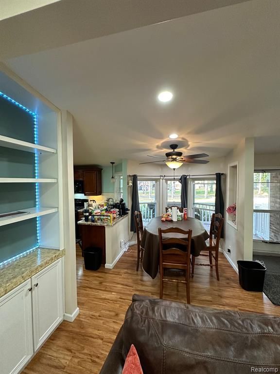 dining room with ceiling fan and light hardwood / wood-style floors