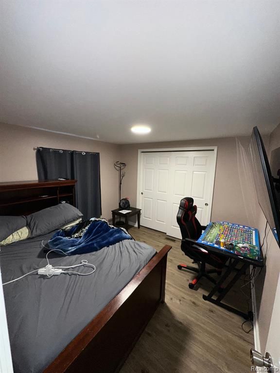 bedroom with hardwood / wood-style flooring and a closet