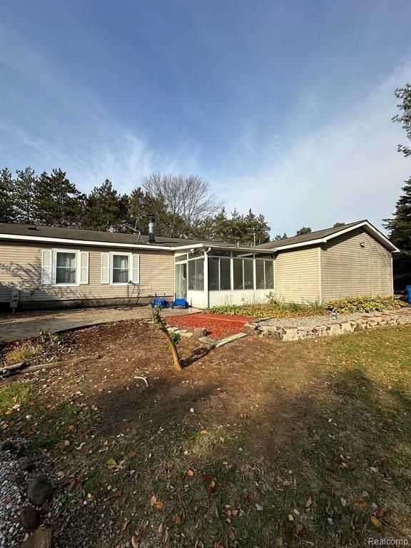 rear view of property with a sunroom