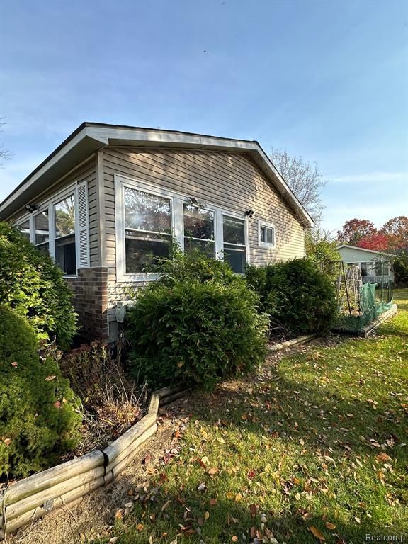 view of property exterior featuring a lawn