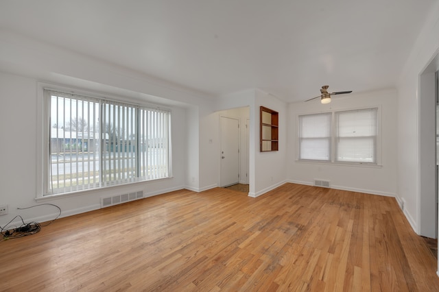 unfurnished room with light hardwood / wood-style flooring and ceiling fan