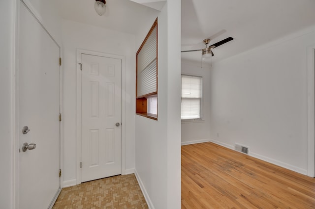 hallway with light hardwood / wood-style floors