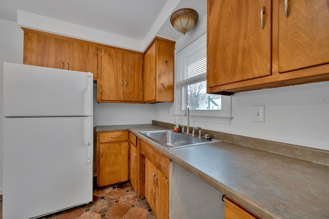 kitchen with sink and white refrigerator