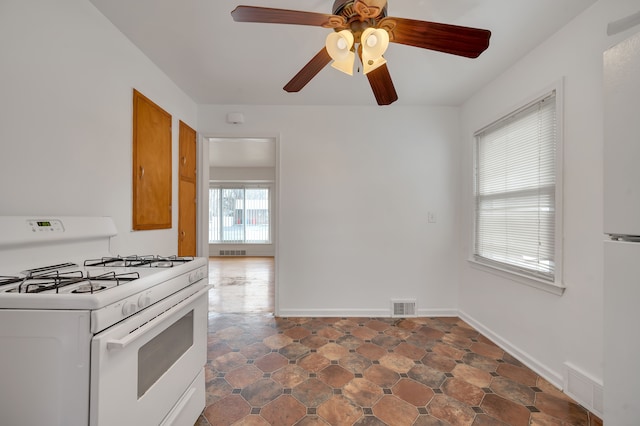 kitchen featuring white gas stove and ceiling fan