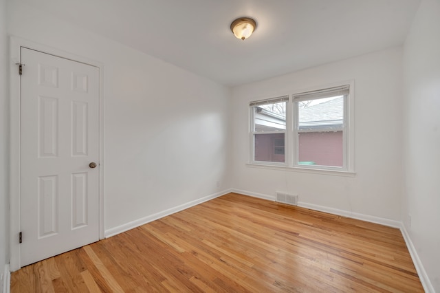 spare room featuring light hardwood / wood-style flooring