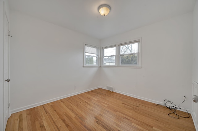 empty room with light hardwood / wood-style floors