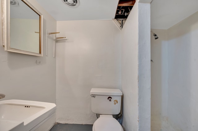 bathroom with walk in shower, toilet, and concrete flooring