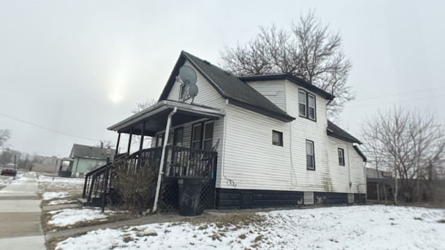 view of snow covered exterior featuring a porch