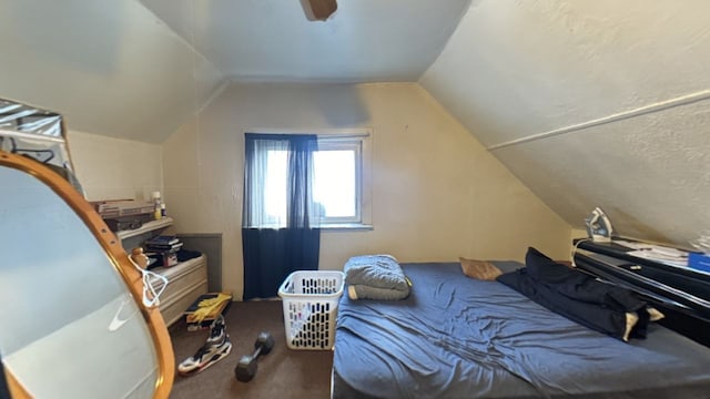 bedroom with vaulted ceiling, carpet flooring, and ceiling fan