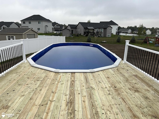 view of swimming pool with a wooden deck