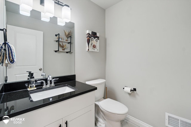 bathroom featuring vanity and toilet