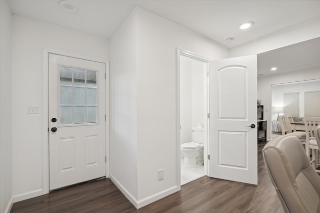 entryway with dark hardwood / wood-style flooring