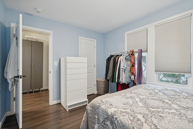 bedroom with dark hardwood / wood-style flooring