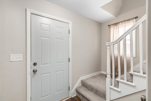 view of carpeted foyer entrance