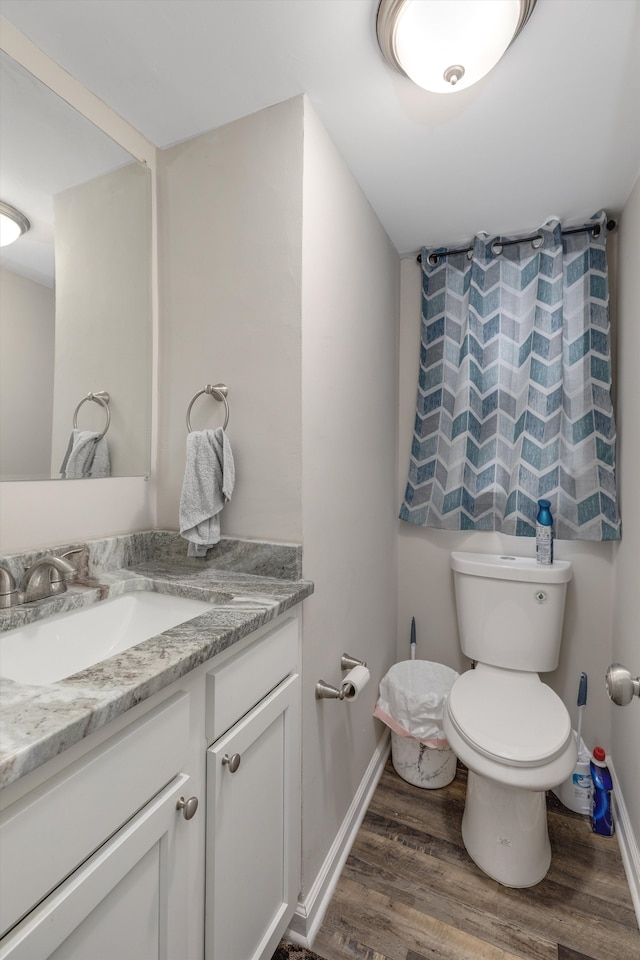 bathroom featuring vanity, hardwood / wood-style floors, and toilet