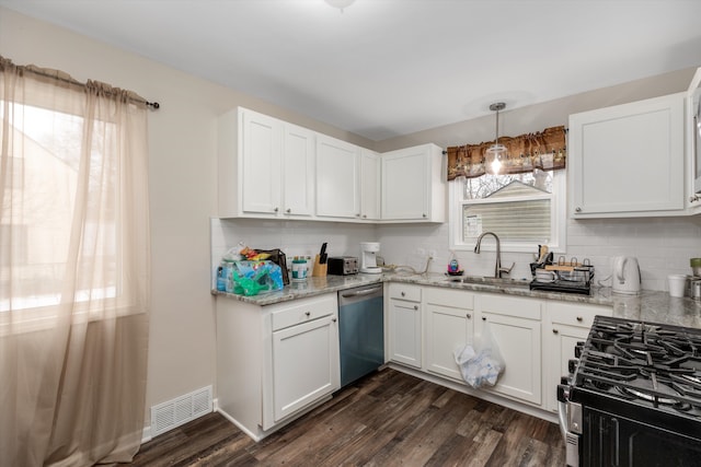 kitchen with pendant lighting, sink, appliances with stainless steel finishes, white cabinetry, and light stone countertops