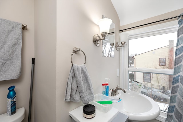 bathroom with vanity, a notable chandelier, lofted ceiling, and toilet