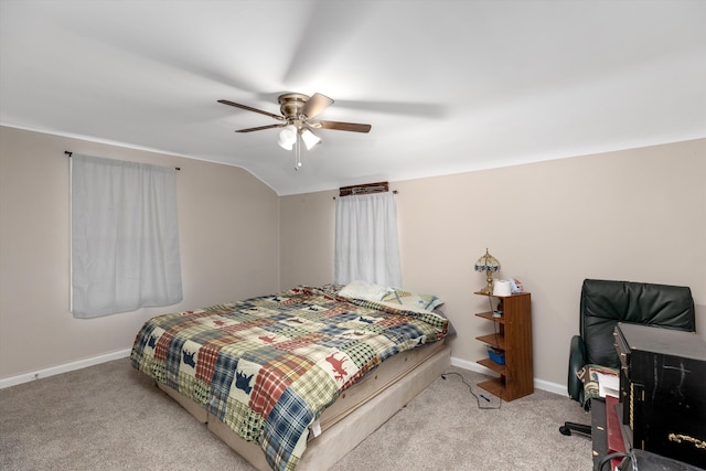 bedroom with ceiling fan, lofted ceiling, and carpet floors