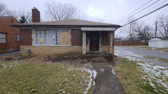 view of front of property featuring fence, a chimney, a shingled roof, stone siding, and brick siding