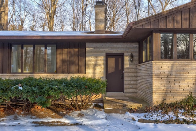 view of snow covered property entrance