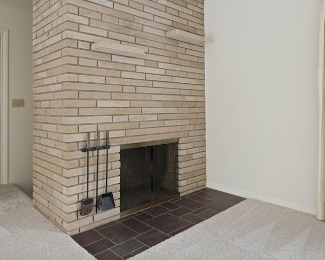 interior details featuring carpet floors and a brick fireplace