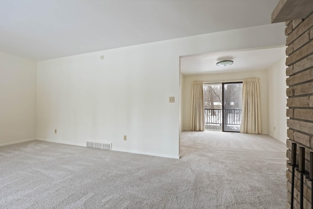 unfurnished living room featuring light carpet and a fireplace