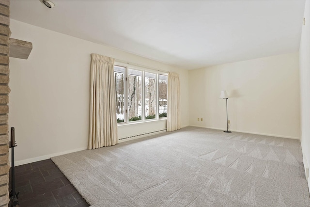 empty room with a baseboard radiator and carpet