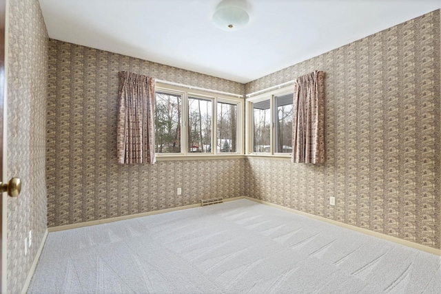 carpeted spare room with a healthy amount of sunlight