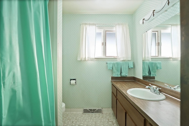 bathroom featuring tile patterned flooring, vanity, and toilet