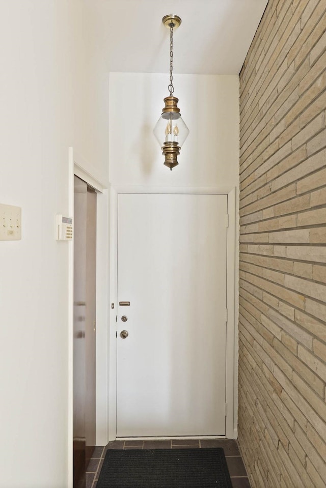 doorway to outside featuring wooden walls