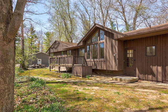 exterior space featuring board and batten siding and a deck