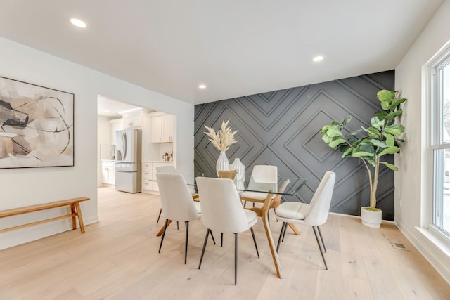 dining area featuring a healthy amount of sunlight and light hardwood / wood-style floors