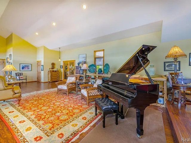 misc room featuring hardwood / wood-style flooring and high vaulted ceiling