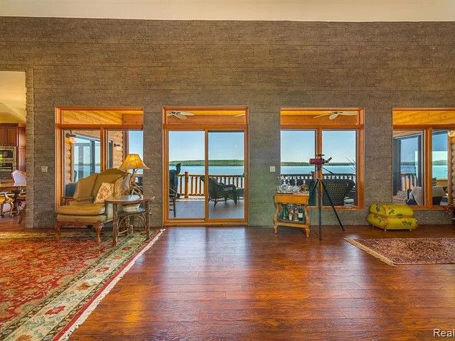 interior space featuring dark hardwood / wood-style flooring, a wealth of natural light, and a water view