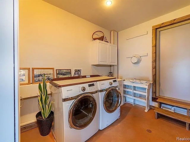 laundry area with cabinets and washing machine and dryer