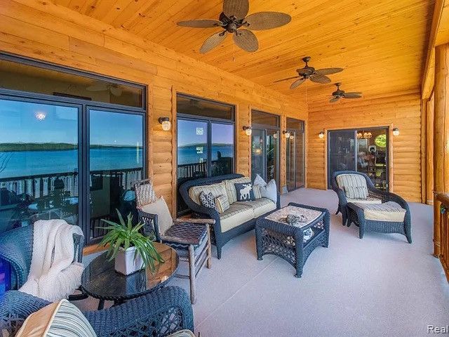 view of patio / terrace featuring outdoor lounge area, ceiling fan, and a water view