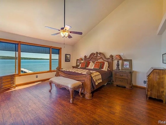 bedroom with lofted ceiling, dark hardwood / wood-style flooring, ceiling fan, and a water view