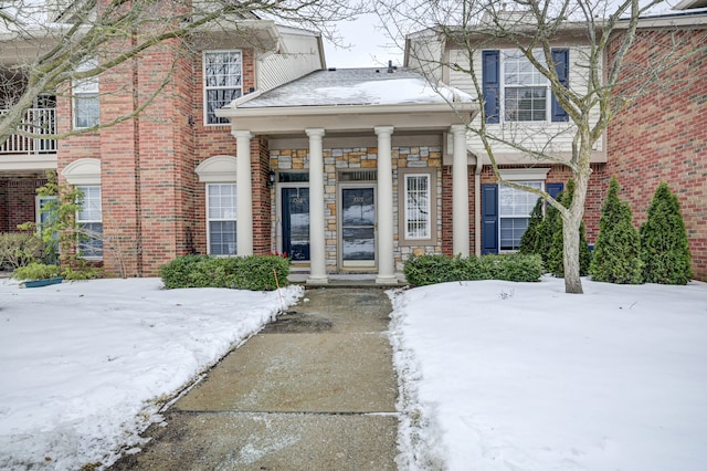 view of snow covered property entrance