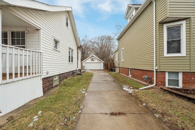 view of side of home featuring a garage and an outdoor structure