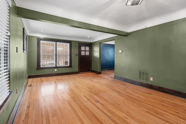 interior space with beamed ceiling and light wood-type flooring